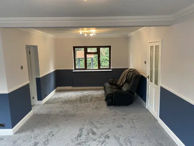 Large living room with navy below the dado rail and soft white walls above