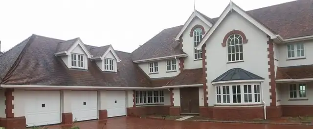 Large house with freshly painted white render and red brick detail